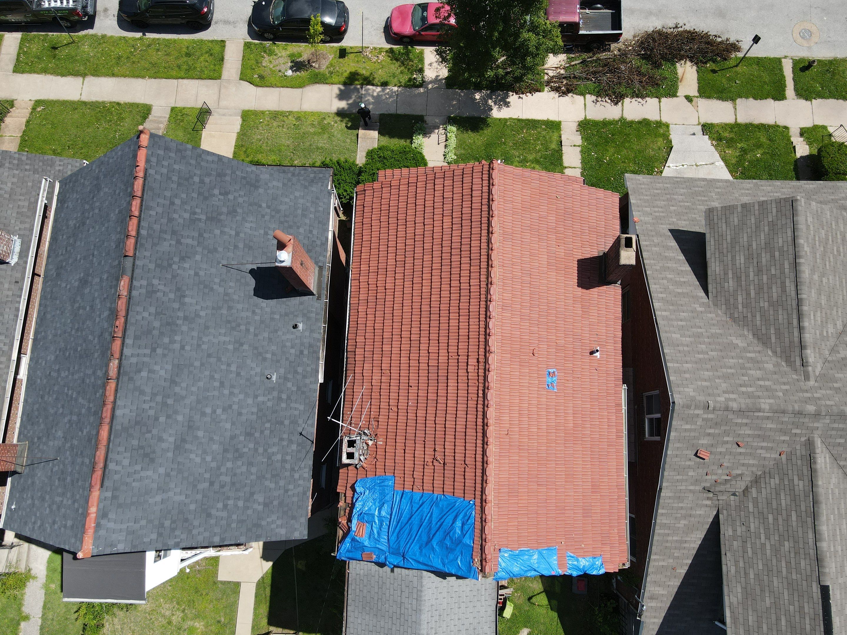 Aerial view of storm damage to a roof in DFW